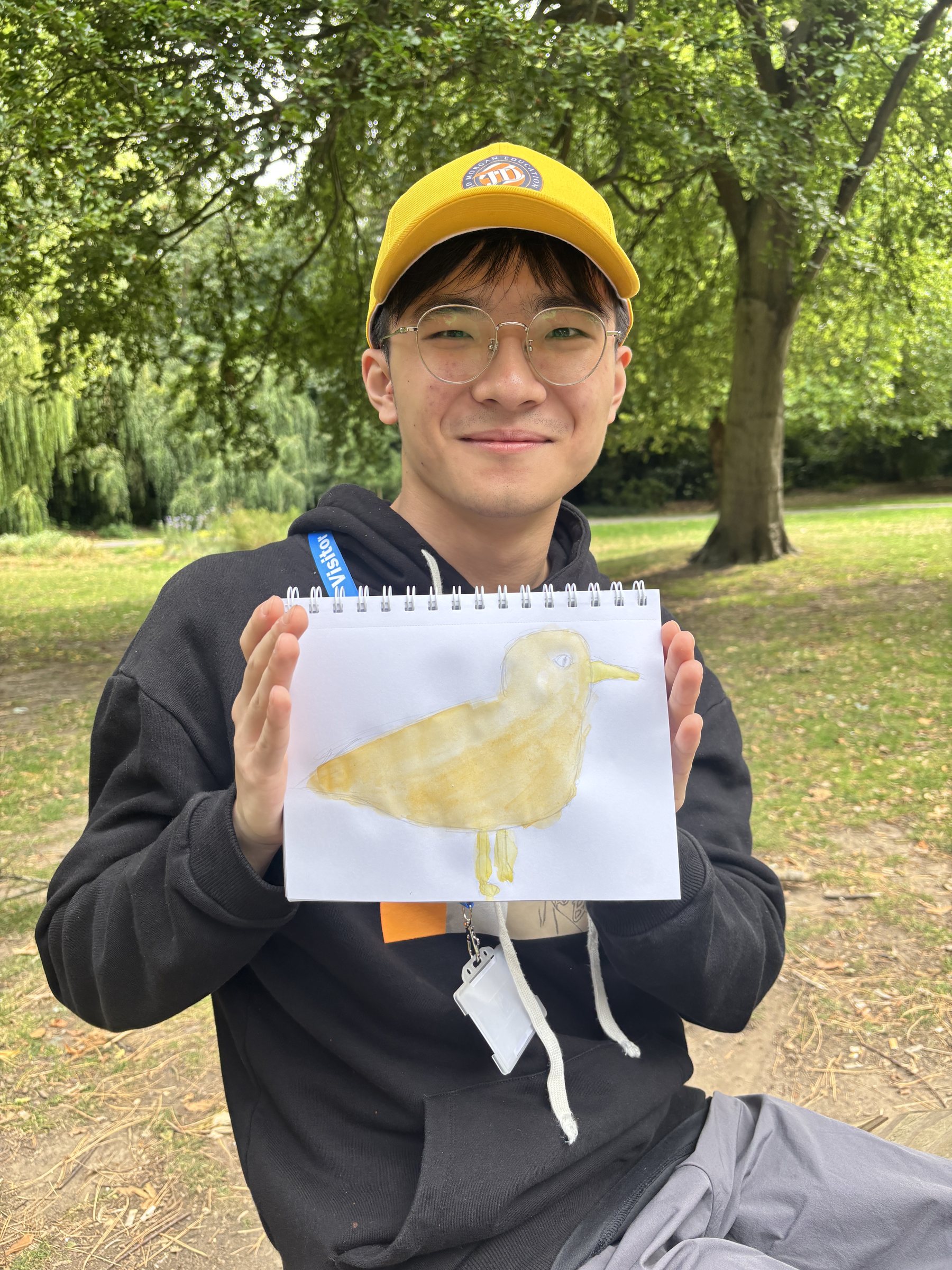 A student presents her watercolour painting in a UK park
